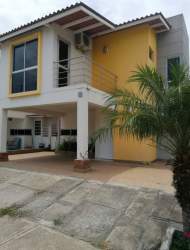 Contemporary yellow and white two-story house balcony driveway Santillana Residencial Arraijan Panama