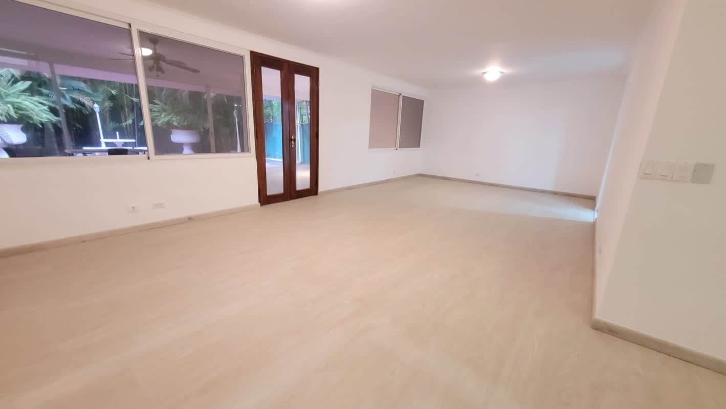 Second bedroom with built-in wardrobe bright window ceramic tile floor Punta Paitilla Panama home