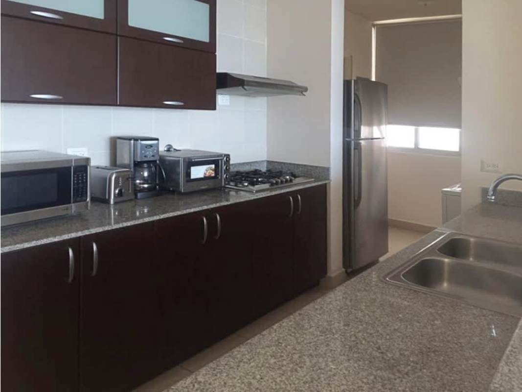 Fully equipped modern kitchen with granite counters, appliances, dark cabinetry in PH Met San Francisco Panama.