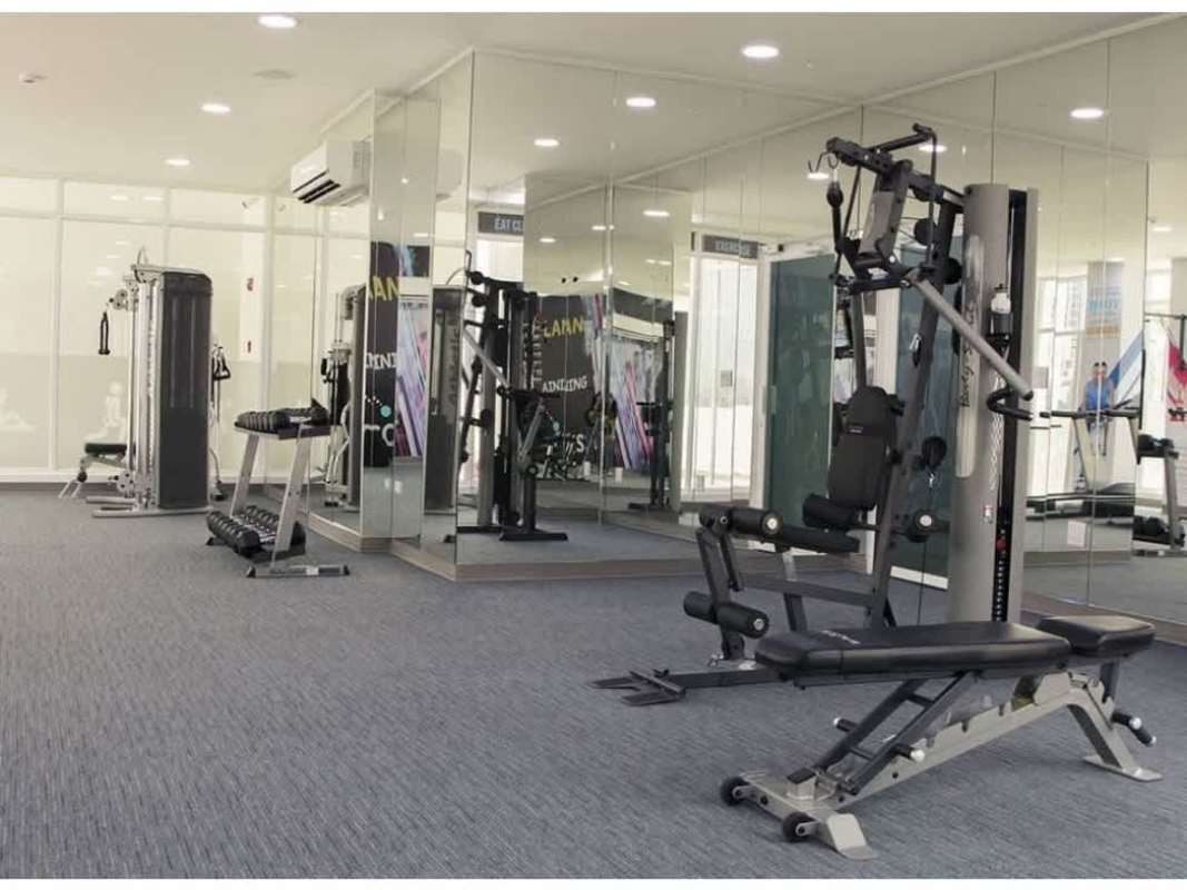 Fully equipped gym with workout machines, mirrored walls at PH Carrasquilla Tower Panama