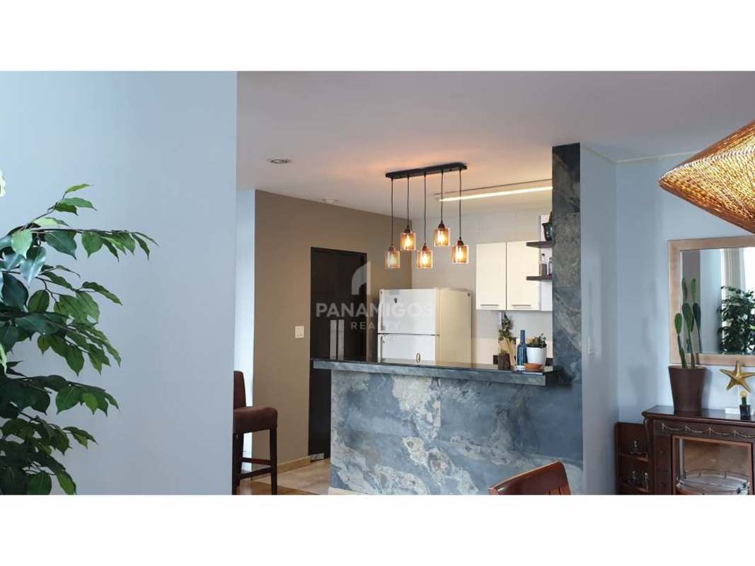 Open kitchen with marble breakfast bar, pendant lighting, and appliances in PH Bayfront Avenida Balboa