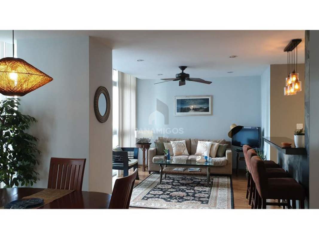 Living and dining room with balcony access and ocean views at PH Bayfront Panama