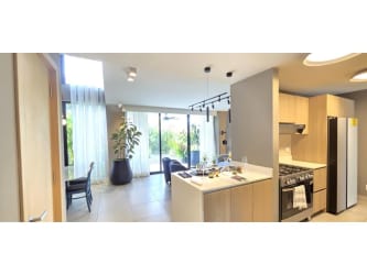 Spacious living-dining area with large windows and sliding glass doors at Imaterra Panama Pacifico home