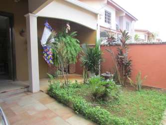 View of tile stairs and spacious living space with dining in two-level home Vista Alegre