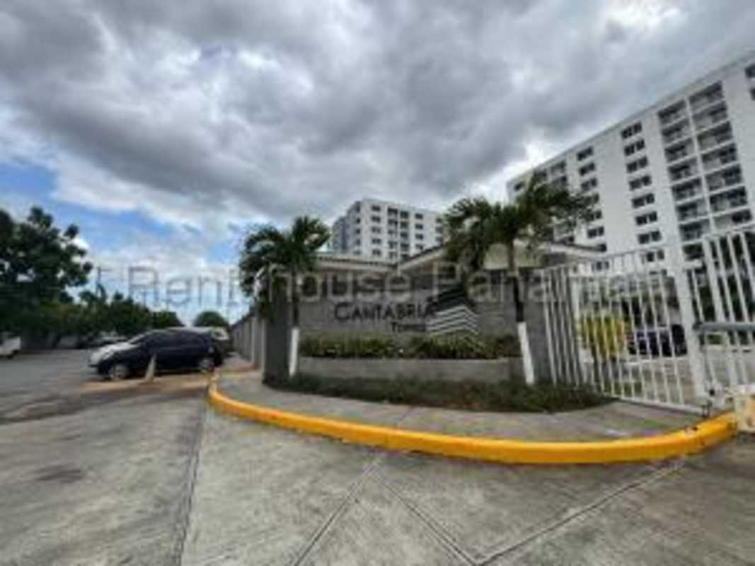 Gated secure community entrance with palm trees Torres de Cantabria Las Acacias Panama