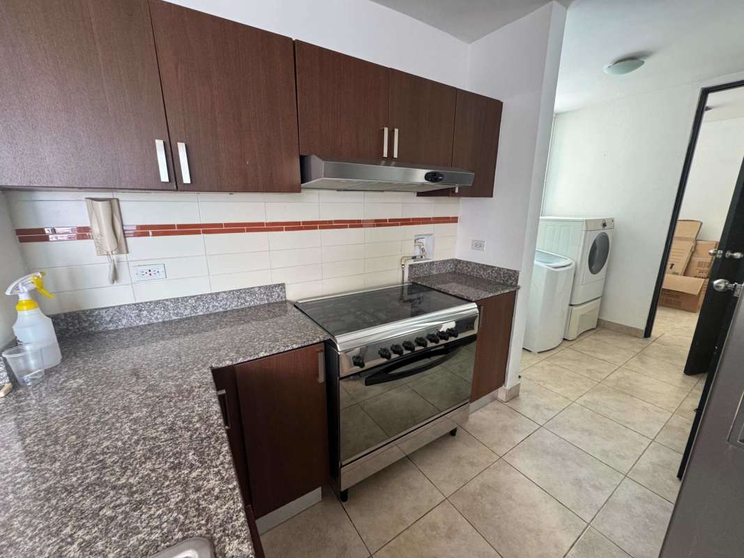 Bedroom featuring closet space and large window with El Cangrejo skyline view in PH Kubic Panama
