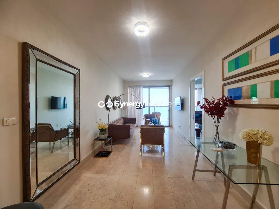 Spacious bedroom with large windows and ocean skyline view in Yoo Panama