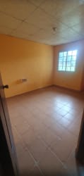 Empty bedroom with tiled floor and window in affordable house La Paz Chame Panama