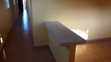 Narrow hallway with tiled half wall ceramic tile floor in La Paz Chame rental house Panama