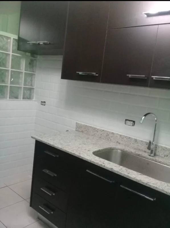 Equipped modern kitchen with granite counters and wood cabinets PH San Francisco Tower Panama