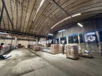 Warehouse interior with arched ceiling and stacked pallets Zon Libre Colon Panama