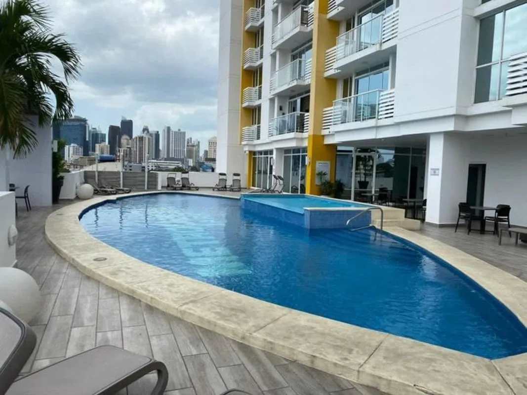 Open kitchen with granite countertops, black refrigerator, oven and microwave PH Vista Hermosa Panama City