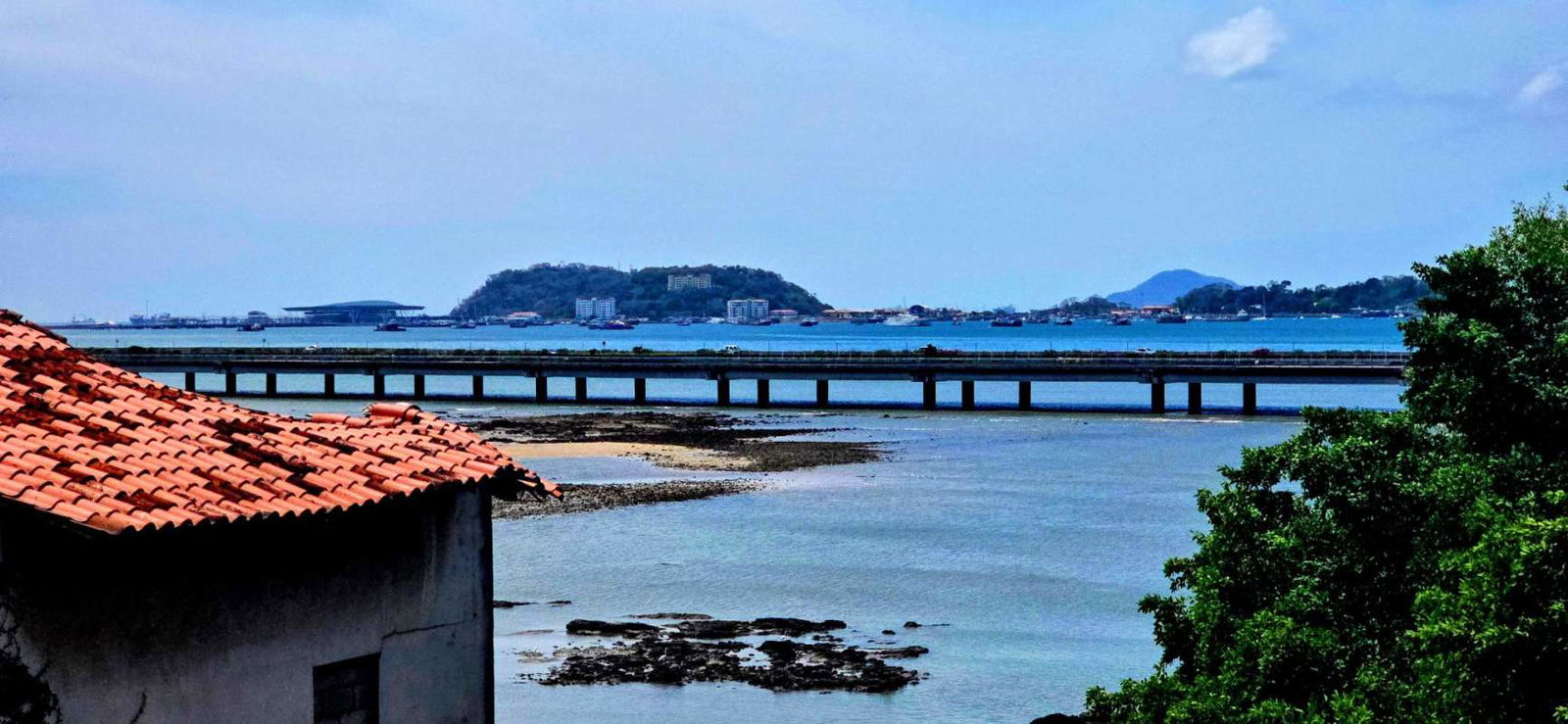 Spacious living dining area with exposed stone wall, balcony access and ocean views Casco Viejo penthouse for rent