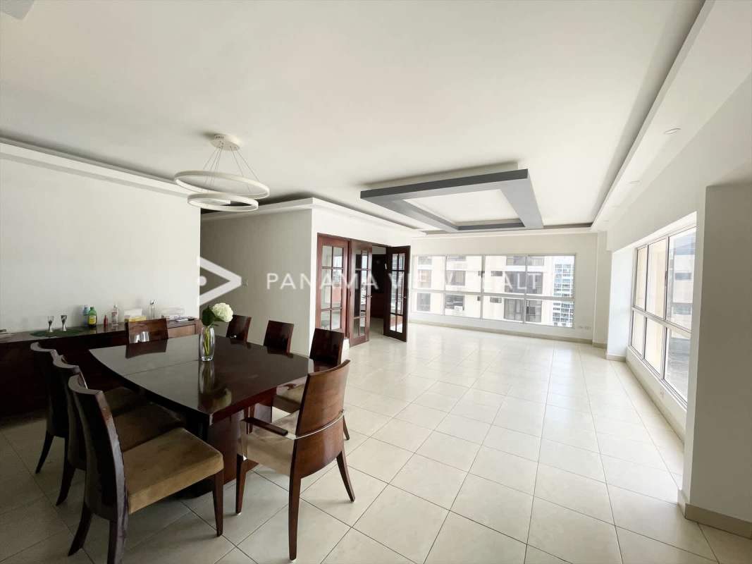 Elegant dining area with large windows overlooking Obarrio city skyline Victoria Tower Panama City