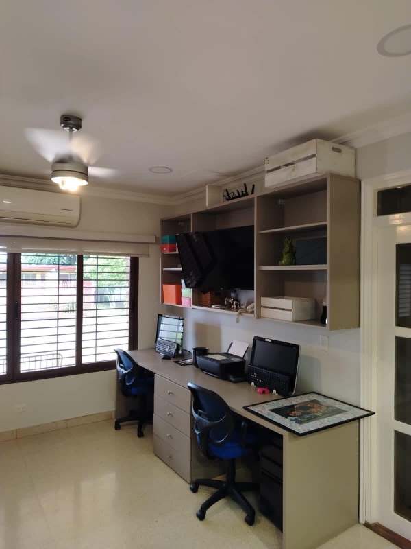 Large living room with sofas, natural light, modern chandelier in house for sale Betania Panama