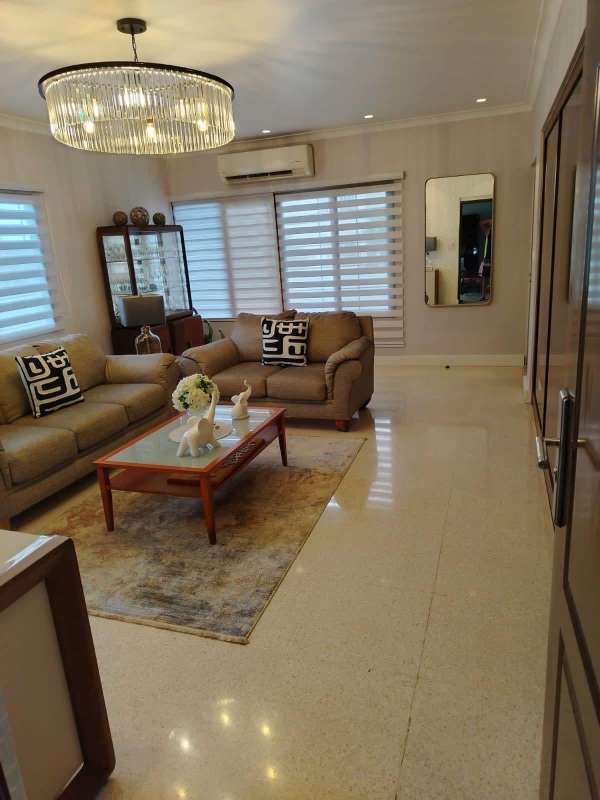 Modern kitchen with wood cabinets, granite counters, appliances Villa de las Fuentes house Panama