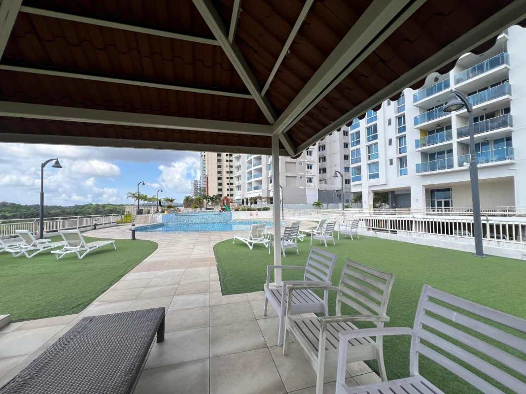 Outdoor swimming pool with lounge chairs pergola and green space PH Lexington Tower Betania Panama City