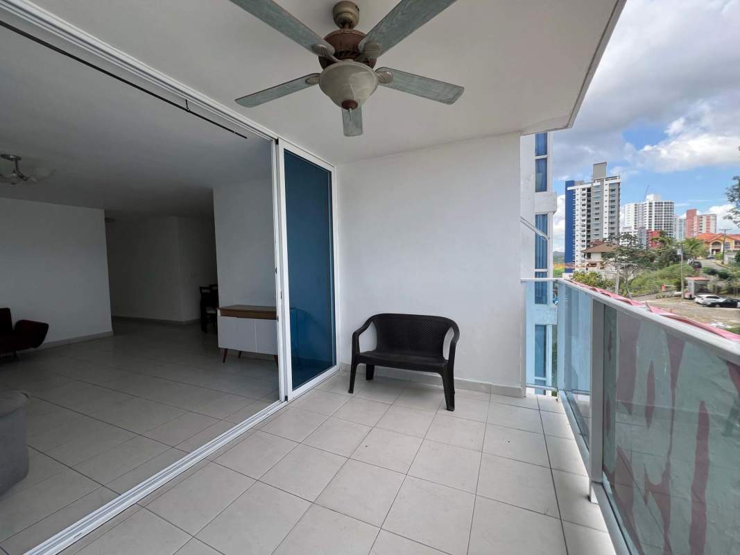 Covered balcony with glass railing and ceiling fan city skyline PH Lexington Tower Panama City