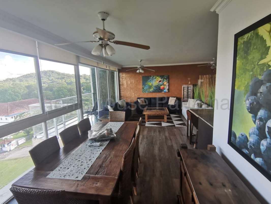 Balcony with outdoor furniture overlooking green gardens at Embassy Club Albrook Panama City