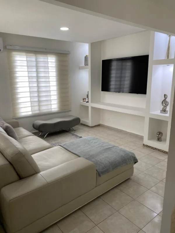 Minimalist living room with sectional sofa, entertainment unit in Residencial Santa Fe Tocumen Panama