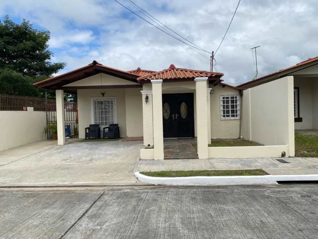 Single-story house with covered porch, tiled roof, driveway, in Santa Fe Panama