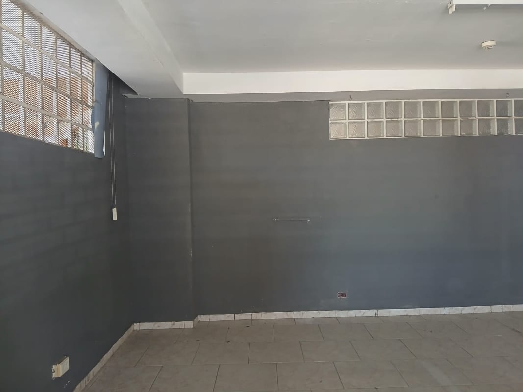 Raw unfinished commercial space with tiled floor and ventilation window in Parque Lefevre Panama