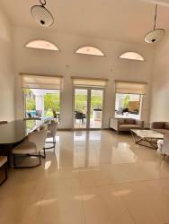 Modern bathroom with neutral tones wood vanity glass shower luxury house Panama