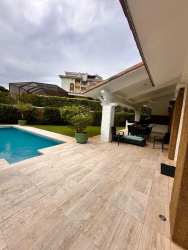 Private pool, large terrace with covered seating in luxury golf course house Panama