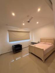Spacious bedroom with balcony and large windows in luxury house Tucan Country Club Panama