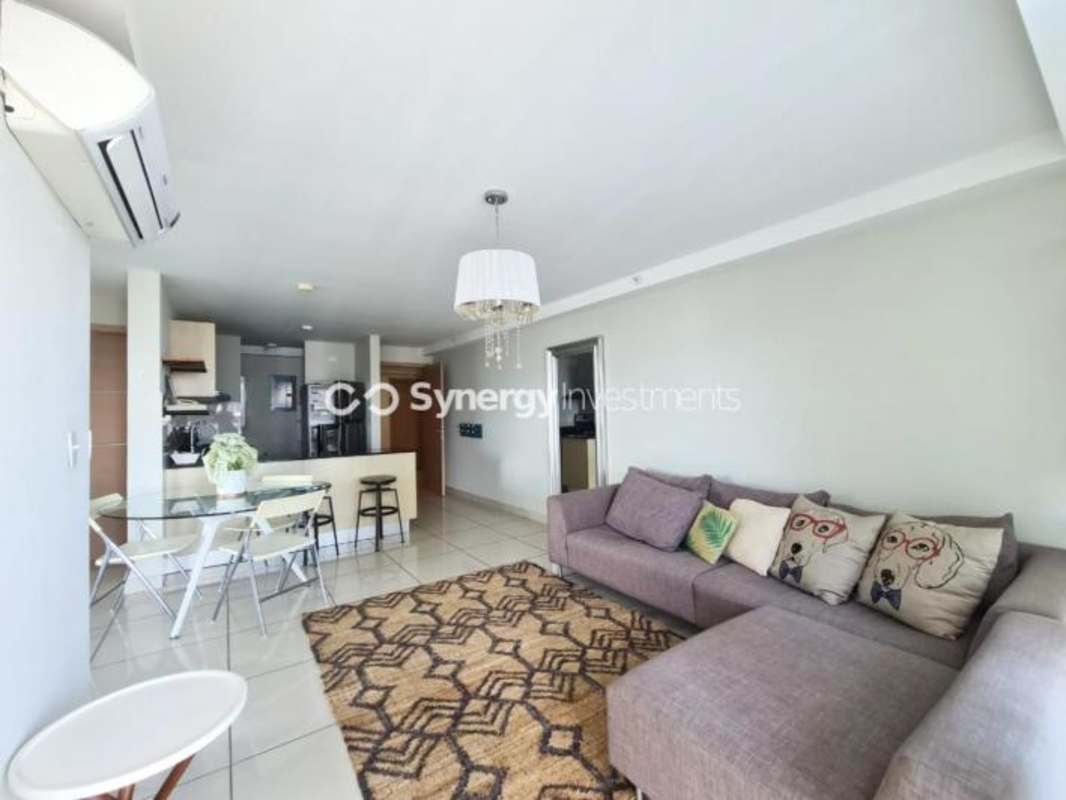 Bright open-plan living room with AC, tiled floors, and dining at PH Carrasquilla San Francisco Panama