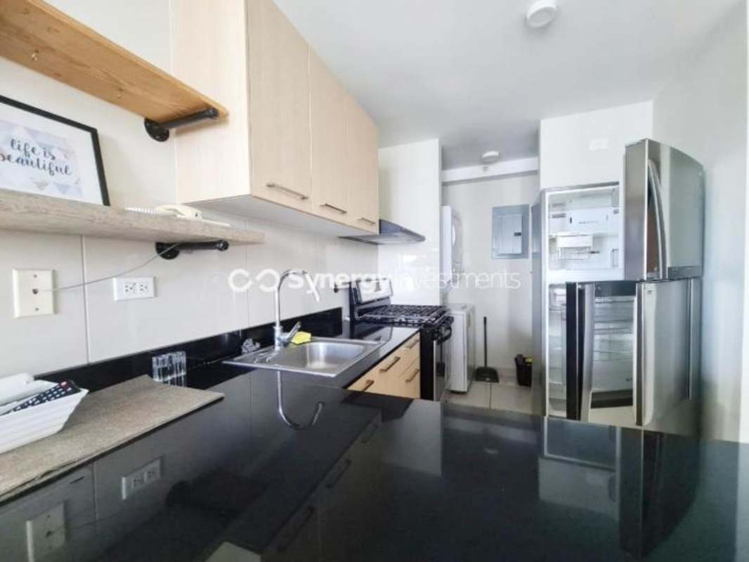 Contemporary kitchen with granite countertops and appliances at PH Carrasquilla San Francisco Panama