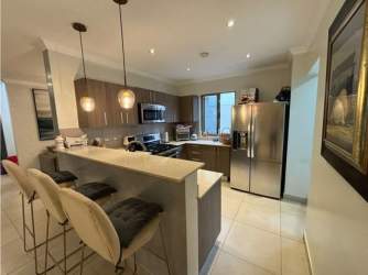 Covered outdoor patio with lounge furniture at Palmia Woodlands Panama Pacifico