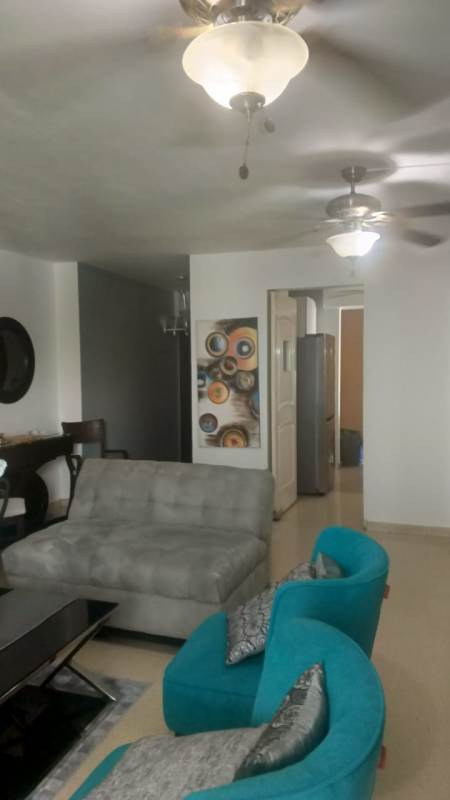 Living and dining area with large windows, marble floors, balcony access in PH El Cangrejo Panama City