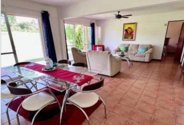 Bedroom with balcony access and garden views in Villa Decameron Rio Hato Panama