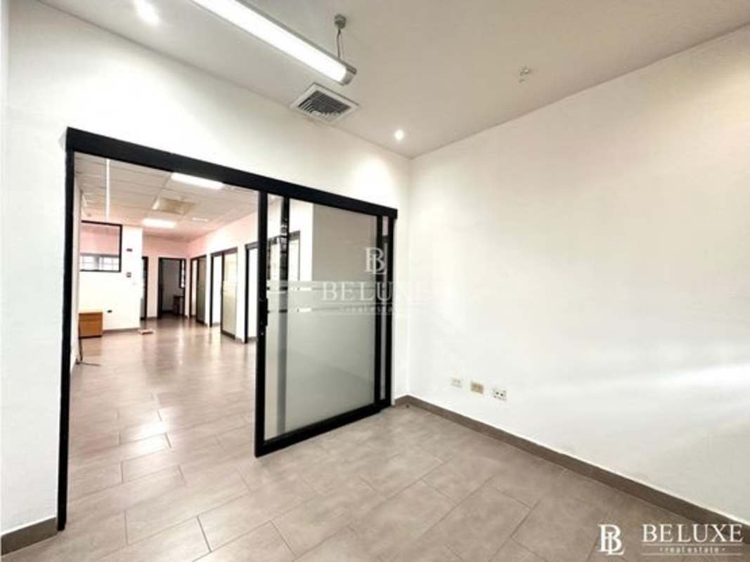 Lobby with staircase, glass doors and modern design in commercial tower Obarrio