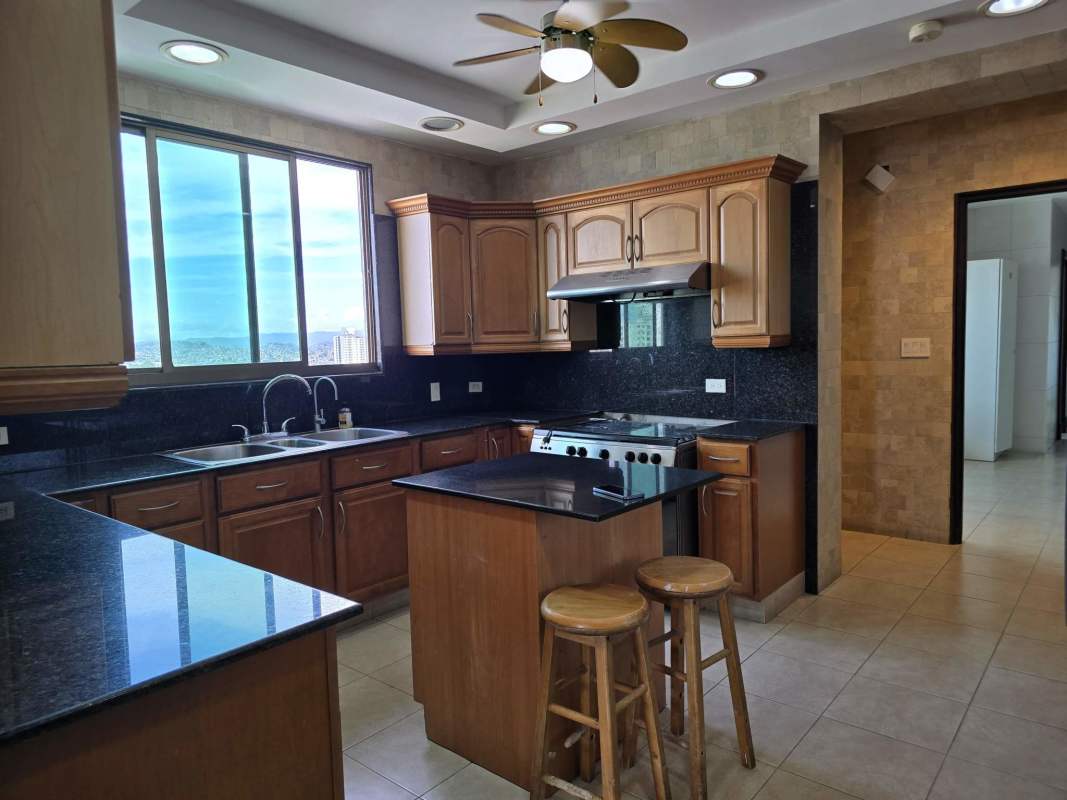 Bright kitchen granite countertop wood cabinets appliances Golf Tower penthouse Panama