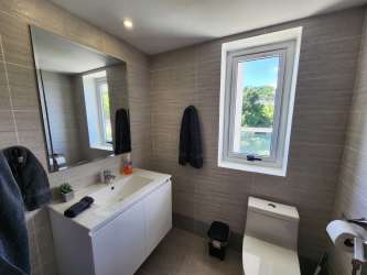 Modern bathroom with glass shower and natural lighting at The Palms El Palmar