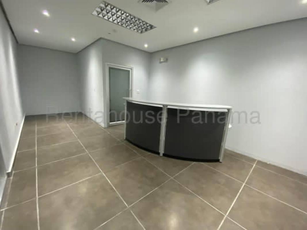 Minimalist reception area with curved desk and tiled floor inside ELMEC Tower office for rent Panama