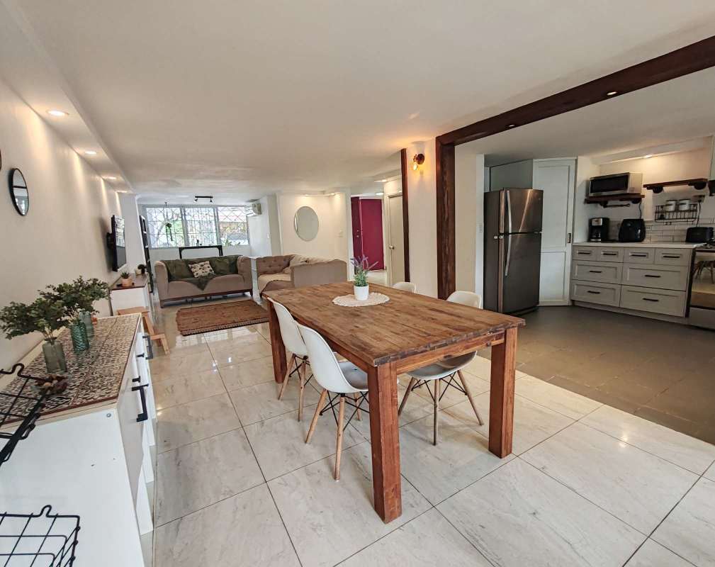 Dining space and kitchen with appliances in furnished home in Coco del Mar Panama