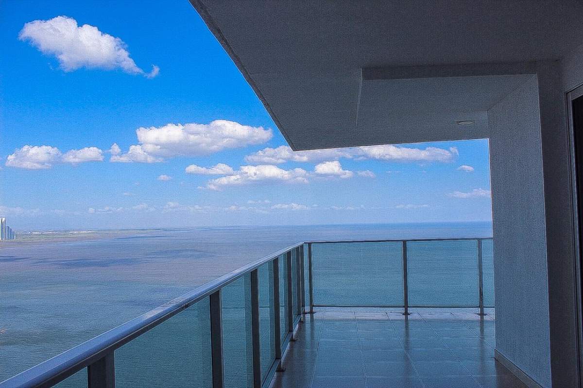 Laundry space with stacked washer dryer heater tank and storage in Punta Pacifica Panama apartment