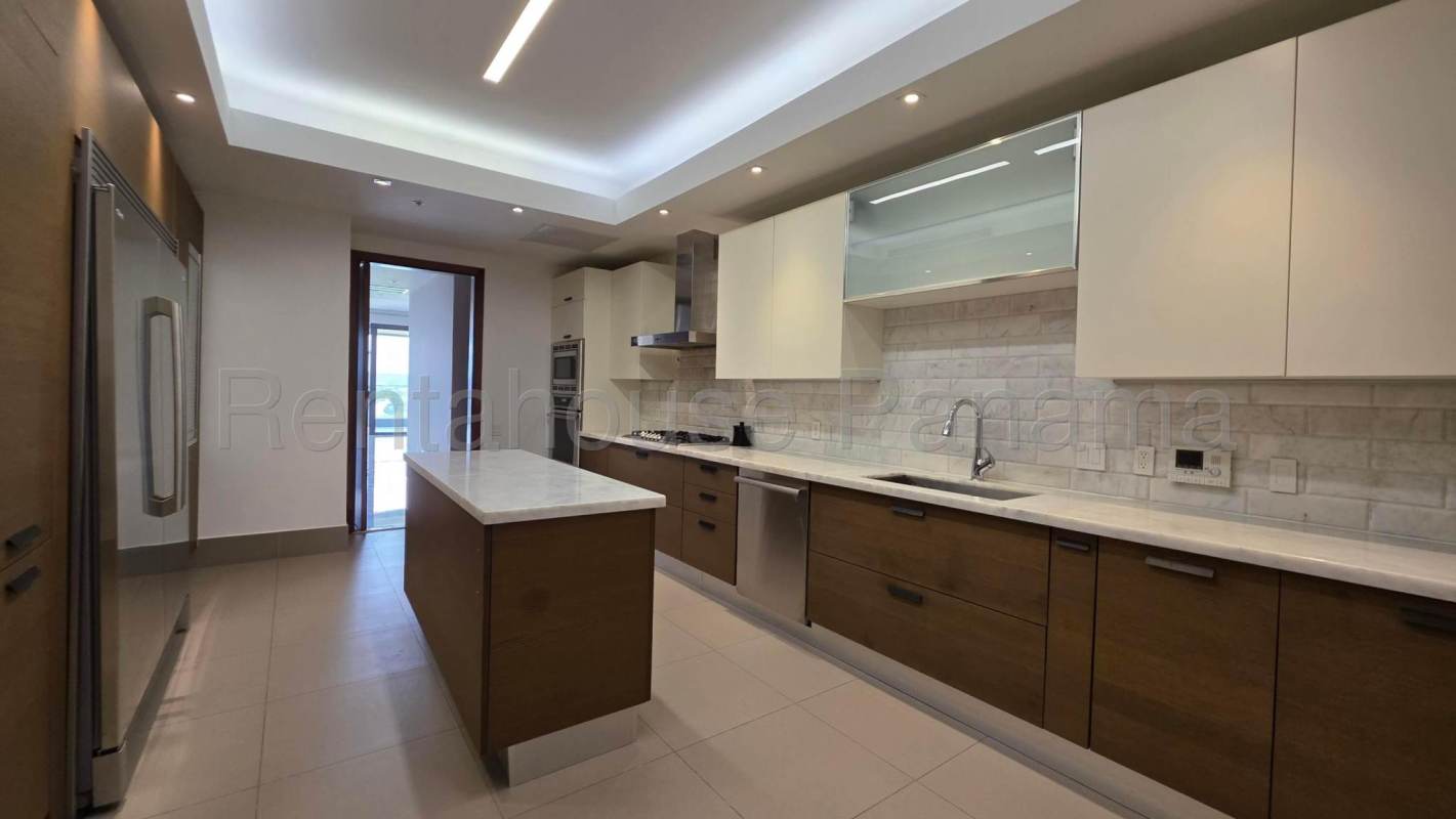Contemporary kitchen with quartz countertops, island, stainless appliances in luxury Santa Maria Panama apartment