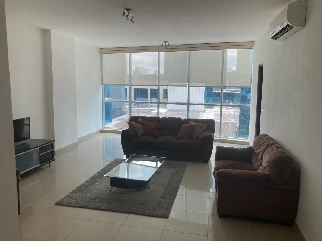 Living area with large windows tiled floors PH Galeria Uno apartment for sale Obarrio Panama City