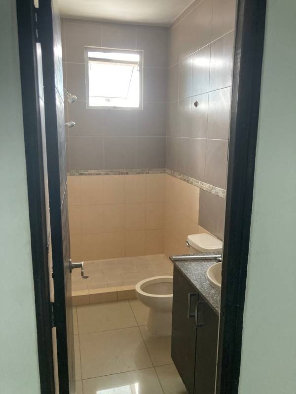 Bathroom beige tile window granite countertop PH Galería Uno Obarrio Panama apartment sale