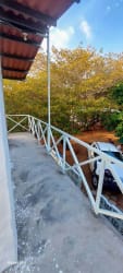 Balcony overlooking countryside with rustic parking at cabin for sale Las Guias Río Hato