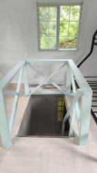 Bright inner hallway and stair rail with garden view inside cabin Las Guias Panama