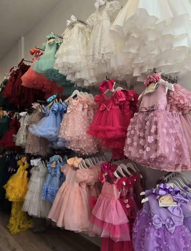 Boutique interior showing colorful children's dresses on racks inside Casa Baby San Francisco Panama City