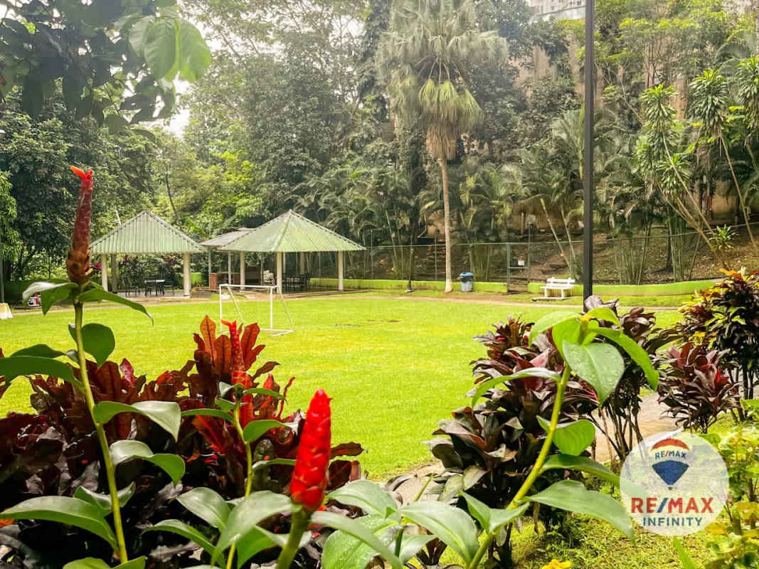 Bathroom with glass enclosed shower, modern vanity, and neutral tiles PH Condado del Rey Panama