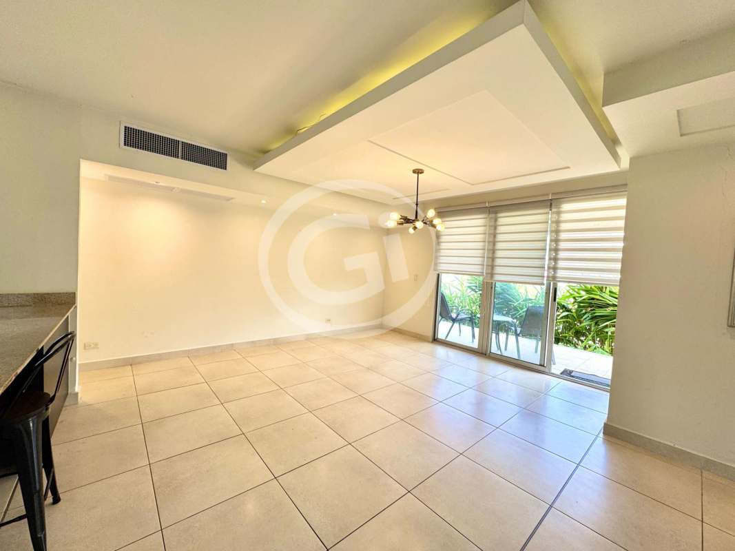 Open modern kitchen with island, granite countertops, built-in appliances in Villasur Costa Sur Panama