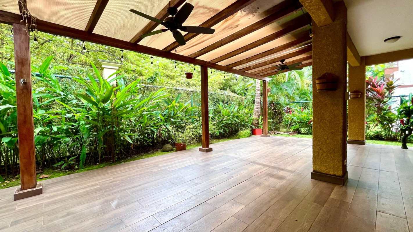 Rustic style covered patio with lush garden Embassy Club Clayton