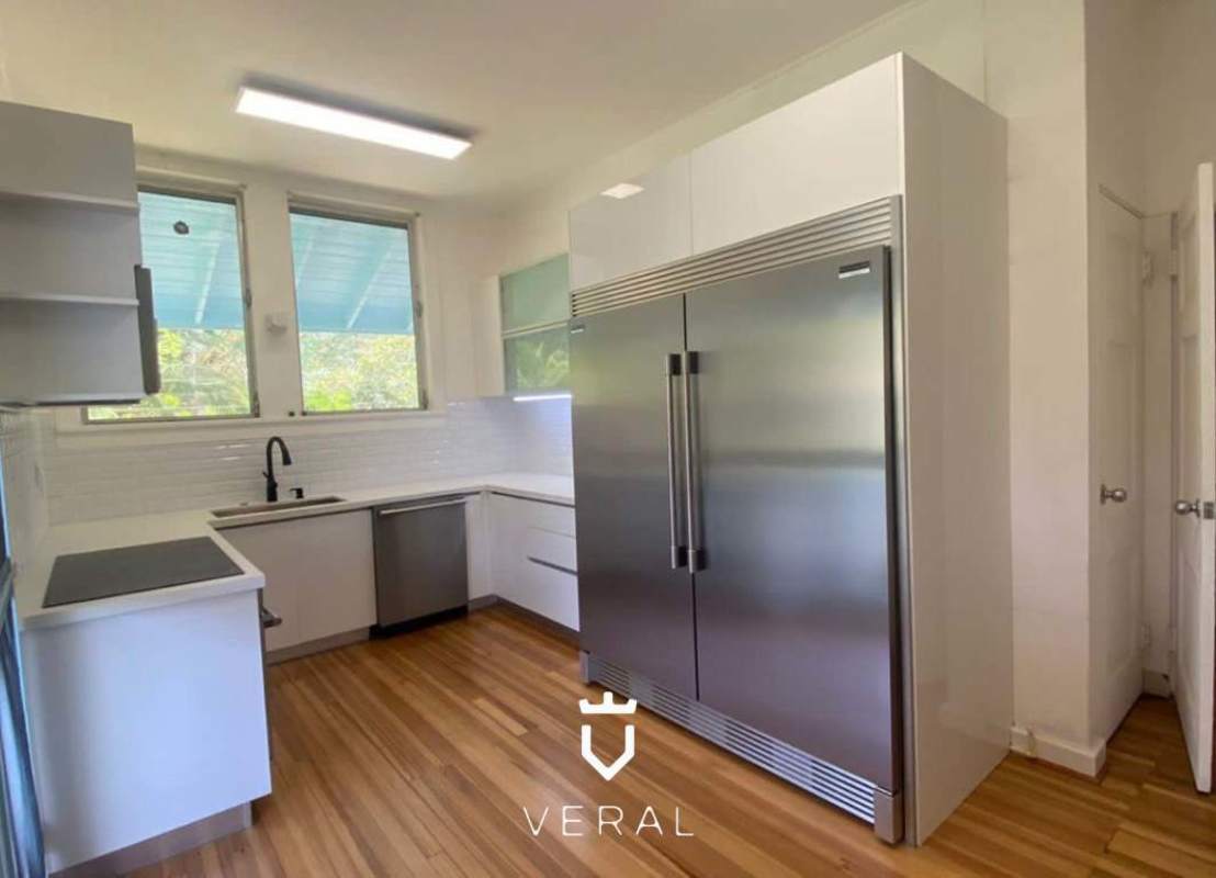 Remodeled kitchen with granite countertops, induction cooktop, twin fridge and oven in Corozal Canal Zone house Panama